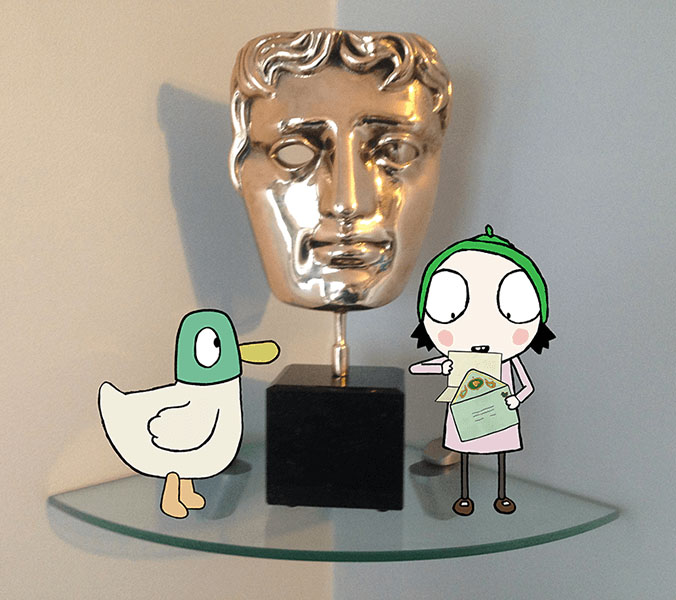 A BAFTA trophy is displayed on a glass shelf, with cartoon characters of a girl and a duck standing in front of it, celebrating as Sarah & Duck win a BAFTA.